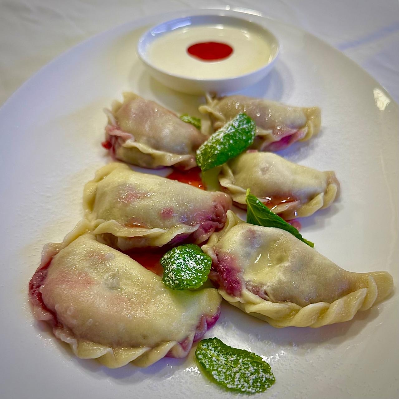 Dumplings with cherry and sour cream